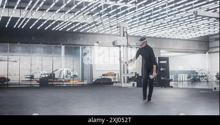 Caucasian Female Car Designer Wearing Virtual Reality Headset and Using Controllers to Work on Concept Car Or Aerodynamics. Talented Design Professional Working in VR Set to Analyze, Test the Vehicle. Stock Photo