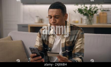 African American man buyer user biracial guy ethnic male client customer order online delivery banking payment booking shopping with credit bank card Stock Photo