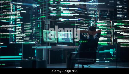 Female Developer Happily Resting After Successfully Typing on Computer Properly Functioning Back-end Code. Professional Programmer Surrounded by Big Screens Showing Coding Language, Creating Software. Stock Photo