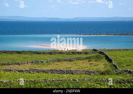 Beautiful Tra Mor beach with large sand dunes with crystal clear waters, Inishmore, Aran Island, Ireland, Stock Photo