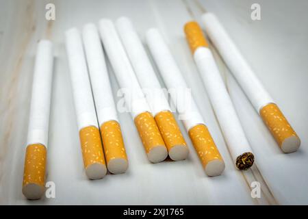 several cigarettes, close-up, spread out on a table Stock Photo