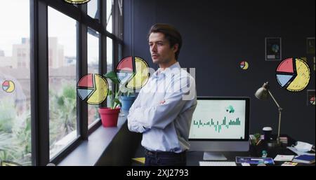 Image of multiple pie graph icons over thoughtful caucasian man looking out of window at office. Computer interface and business data technology conce Stock Photo