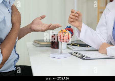 A heart patient attended a hospital for a checkup with a doctor after experiencing chest pain. Doctors are advising patients to take care of their hea Stock Photo