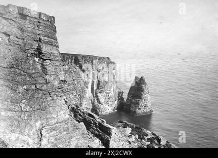 Sugar Loaf Rock at the Chasms, near Port St Mary, Isle of Man.  This photograph is from an Edwardian original, around 1910. The original was part of an album of150 albumen photographs, of variable quality, many of which I have photographed. The collection included images particularly from the Isle of Man and the English county, Devonshire. Annotations were included in the album but, unfortunately, there were no specific dates. Original photos were, on average 6x4 ½ inches. Stock Photo