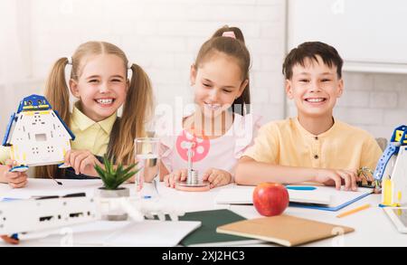 Smiling Children Working On STEM Projects In A Classroom Setting Stock Photo