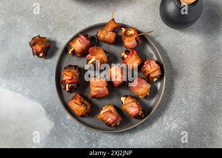 Warm Bacon Wrapped Dates with Goat Cheese Stock Photo