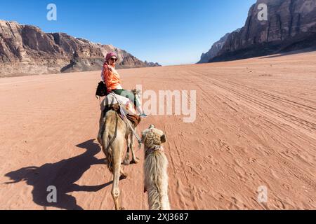 Tourist woman in traditional arabian clothes with camel in the Sinai Desert, Sharm el Sheikh, Sinai Peninsula, Egypt. Stock Photo