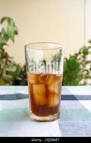 Cold Americano Coffee in a Takeaway Cup for Mockup use. Cold Coffee with Straw and Ice in a Cafe Stock Photo