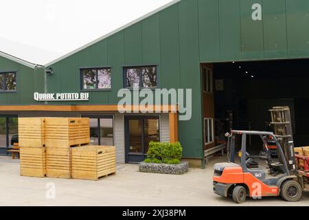 Scherpenisse, Netherlands - May 22, 2023: A forklift is loading crates of potatoes at the Quak Potato BV warehouse in the Netherlands. Stock Photo