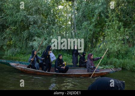 Srinagar, India. 16th July, 2024. Kashmiri Shiite Muslim woman rows her boat during the procession in the interiors of Dal lake in Srinagar on the 9th of Muharram, the first and holiest month the Islamic calendar. Shiite Muslims commemorate Muharram as a month of mourning in remembrance of the martyrdom of Islamic Prophet Muhammad's grandson Imam Hussain, who was killed along with his family members on Ashura (the 10th day of Muharram) in the battle of Karbala in southern Iraq in 680 A.D. (Photo by Faisal Bashir/SOPA Images/Sipa USA) Credit: Sipa USA/Alamy Live News Stock Photo