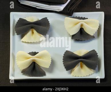 Farfalles with squid ink Stock Photo