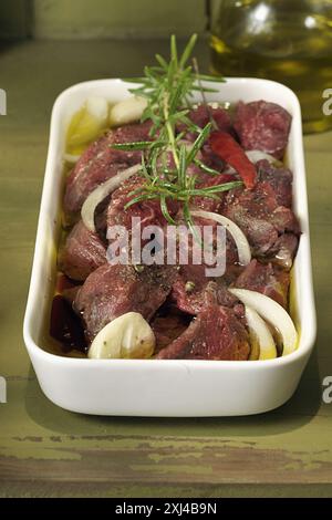 Raw beef marinating in olive oil Stock Photo