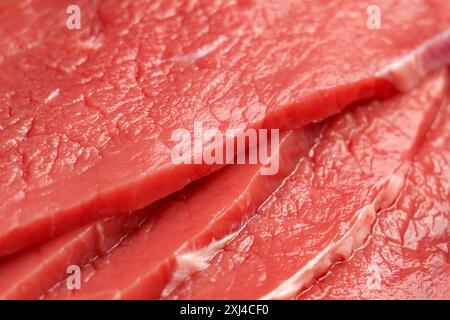 Raw beef escalope. Thinly sliced fresh red meat steak. Close up Stock Photo