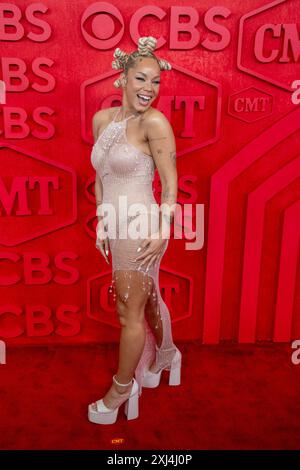 Country singer TANNER ADELL walks the red carpet and poses for