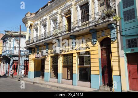 503 South facade of early 1900s, two-storey Eclectic style building on Calles Francisco Aguilera and Monsenor Barnada Streets NE corner. Santiago-Cuba Stock Photo