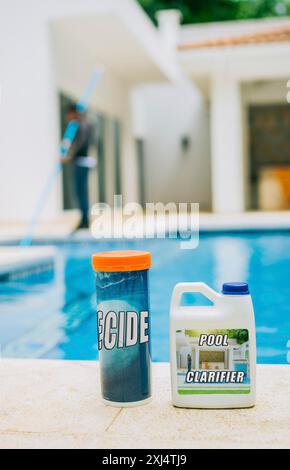Algaecide and clarifier for swimming pools. Clarifying chemical at the edge of a swimming pool Stock Photo