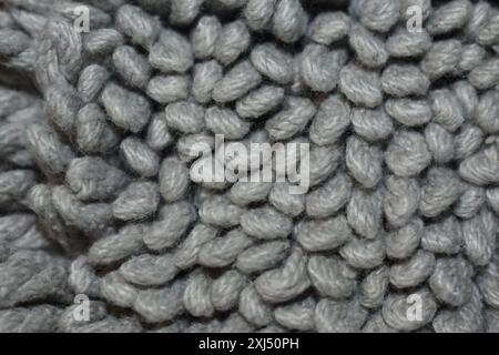 Closeup of the front of a gray colored rug.  Abstract background with copy or text space. Stock Photo