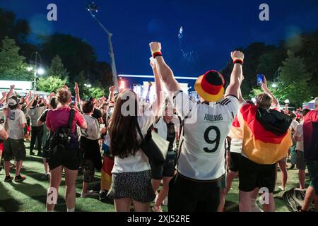 Fans cheer after the 1:0 win for Germany in the fan zone at the Brandenburg Tor during the round of 16 match between Germany and Denmark at the Stock Photo