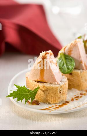 Foie gras on a bite-size slice of bread Stock Photo