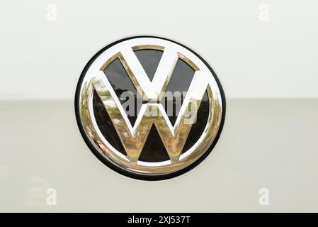 Shiny, silver Volkswagen logo, emblem with black interior on white background, golden reflection, Lower Saxony, Germany Stock Photo