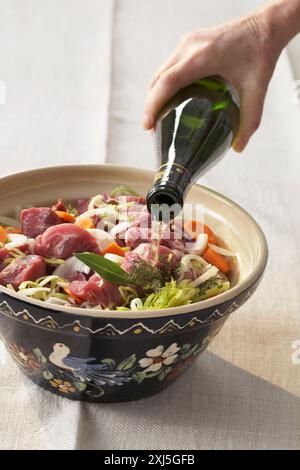 marinating the meat,carrot and onions in red wine Stock Photo