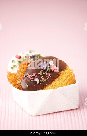 Cookies coated with chocolate and crystallized flowers Stock Photo