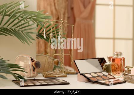 Makeup products on table in dressing room, closeup Stock Photo
