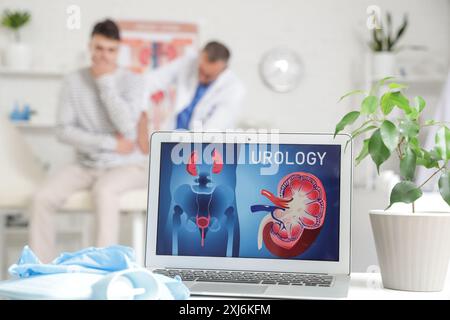 Open laptop on table in urologist's office, closeup Stock Photo