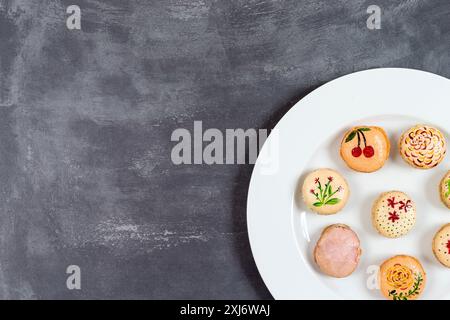 Assortment of decorated Macarons on a plate Stock Photo