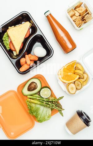 flat lay of yummy lunch and fruits in lunch boxes isolated on white Stock Photo