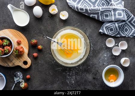 top view of making cream for pie process and arranged ingredients on dark grey surface Stock Photo