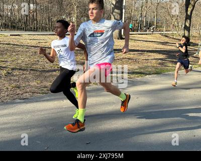 Youth running group training  in Prospect Park in Brooklyn, NY. The group includes students from elementary school, Junior high school and high school. Stock Photo