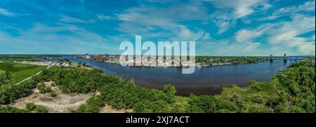 Aerial panorama view of Wilmington North Carolina historic district along the Cape Fear river, with the North Carolina battleship with cloudy sky Stock Photo