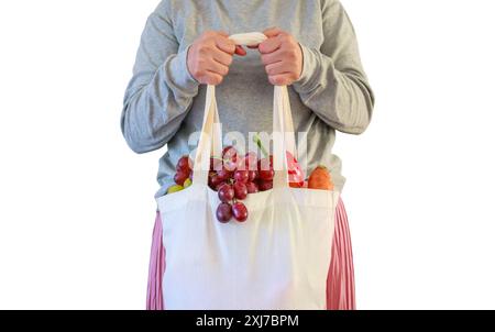 Woman hold eco friendly reusable shopping bag filled with full fresh fruits and vegetables grocery product isolated on white background with clipping Stock Photo