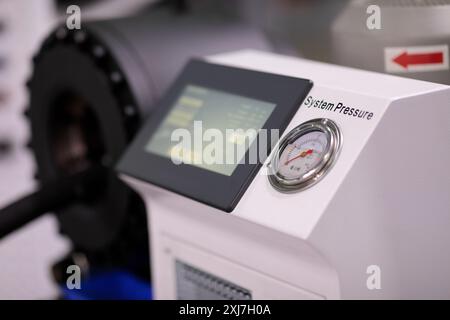 Modern industrial control console with touchscreen and pressure gauge. Selective focus. Stock Photo