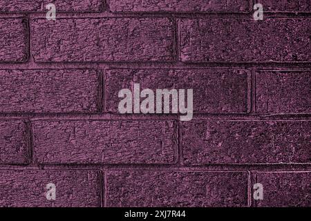 Purple indoor brick wall background.  Abstract indoor brickwork with colour gradient. Stock Photo