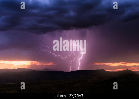 Dramatic sunset sky and monsoon lightning storm in the desert near Carefree, Arizona Stock Photo