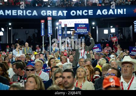 Milwaukee, Vereinigte Staaten. 16th July, 2024. Attendees hold up Trump signs at the Republican National Convention in Milwaukee, Wisconsin at the Fiserv Forum on Tuesday, July 16, 2024. Credit: Annabelle Gordon/CNP/dpa/Alamy Live News Stock Photo