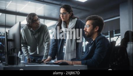 Team of Three Multiethnic Diverse Software Developers Talk, Discuss an AI Project. Stylish Young Indian Female and Male Specialists Work on Digital E-Commerce Startup Business Stock Photo
