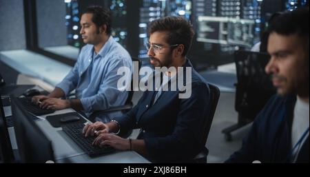 Team of Three Multiethnic Diverse Software Developers Work in Technological Office. Empowered Young Indian Specialists Work on Digital E-Commerce Startup Business Stock Photo