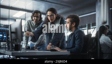 Team of Three Diverse South Asian Software Developers Talk, Discuss a Technological Project. Empowered Indian Female Specialists and Two Colleagues Work on Digital Software as a Service Business Stock Photo