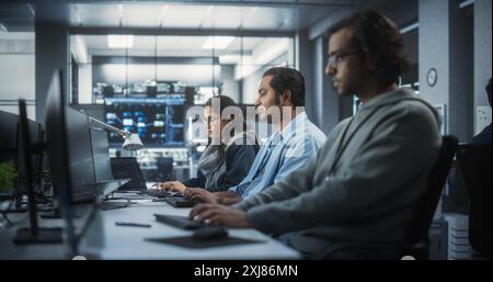 Team of Talented Young Indian Professionals Working in a Technological Research and Development Agency. Computer Screens with Software Code and Technical Neural Network Diagrams Stock Photo