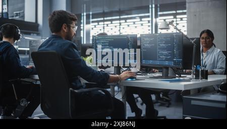 Team of Talented Young Indian Professionals Working in a Technological Research and Development Agency. Computer Screens with Software Code and Technical Neural Network Diagrams Stock Photo