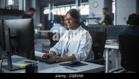 Positive Technical Support Manager Talking on a Call, Providing Help Desk Solutions to a Customer Experiencing Troubleshooting Issues with a Product. Indian Female Successfully Solving the Problem Stock Photo