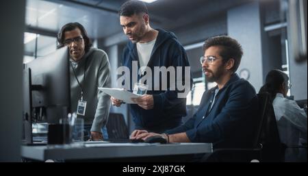 Team of Three Multiethnic Diverse Software Developers Talk, Discuss and Collaborate on an AI Project. Empowered Young Indian Specialists Work on Digital E-Commerce Startup Business Stock Photo