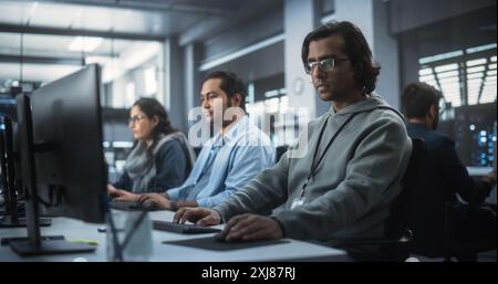 Group of Multicultural South Asian Men and Women Working in a Research Center, Collaborating and Discussing a Project, Using Computers to Write Software Code, Develop Artificial Intelligence Service Stock Photo