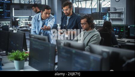 Team of Three Multiethnic Diverse Software Developers Talk, Discuss and Collaborate on an AI Project. Empowered Young Indian Specialists Work on Digital E-Commerce Startup Business Stock Photo