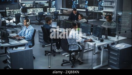 Diverse Young Indian Colleagues Working on Computers in a Research Laboratory. Focus on Female Software Developer Colleague Working on a Solution for Their Collaborative Industrial Tech Project Stock Photo