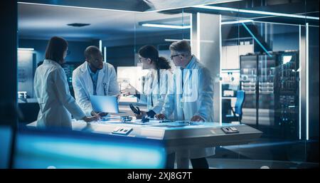 Team of Tech Scientists Having a Group Meeting in Research and Development Facility at a Robot Manufacturing Factory. Engineers Examining an Innovative Robotic Bionic Hand Concept. Stock Photo