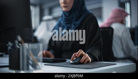 Close Up of a Middle Eastern Engineer Working on Computer in a Technological Corporate Office. Young Muslim Woman Writing Software Code for an Innovative Internet and Software as a Service Project Stock Photo